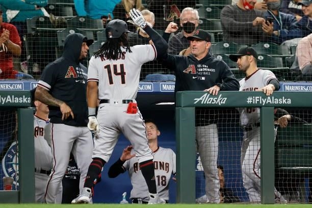 Manager Torey Lovullo congratulates Henry Ramos of the Arizona Diamondbacks after his home run against the Seattle Mariners during the second inning...