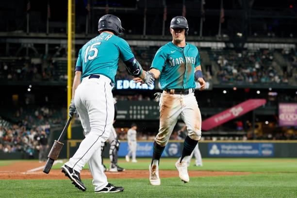 Kyle Seager congratulates Dylan Moore of the Seattle Mariners after a run during the fifth inning against the Arizona Diamondbacks at T-Mobile Park...