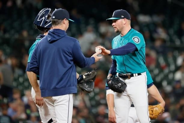 Manager Scott Servais receives the ball from Anthony Misiewicz of the Seattle Mariners during the game against the Arizona Diamondbacks at T-Mobile...