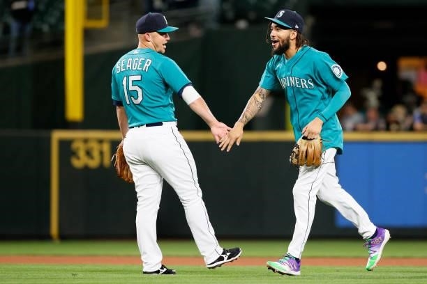 Kyle Seager and J.P. Crawford of the Seattle Mariners react after beating the Arizona Diamondbacks 5-4 at T-Mobile Park on September 10, 2021 in...