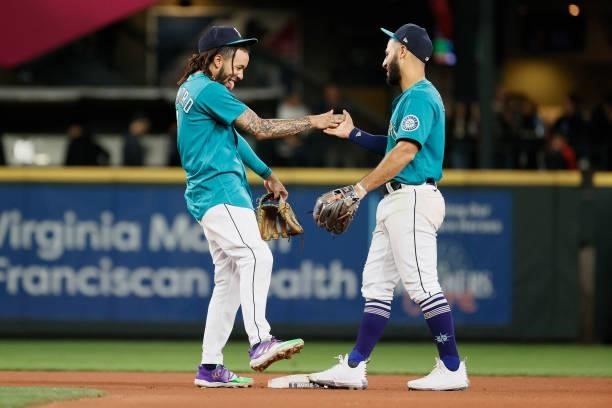 Crawford and Abraham Toro of the Seattle Mariners react after defeating the Arizona Diamondbacks 5-4 at T-Mobile Park on September 10, 2021 in...