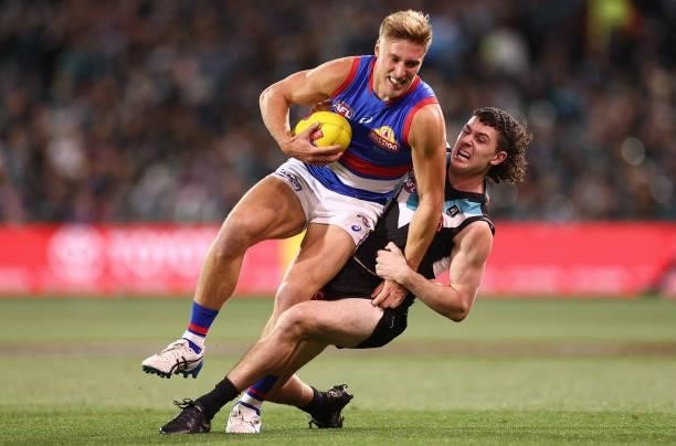 Roarke Smith of the Bulldogs is tackled by Darcy Byrne-Jones of the Power during the AFL Second Preliminary Final match between Port Adelaide Power...