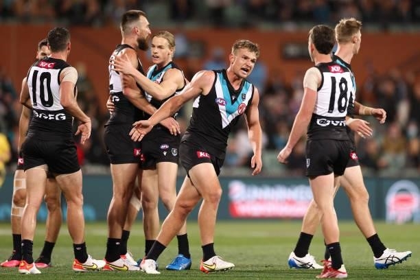 Ollie Wines of the Power is congratulated by team mates after kicking a goal during the AFL Second Preliminary Final match between Port Adelaide...