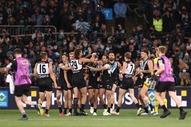 Dan Houston of the Power is congratulated by team mates after kicking a goal during the AFL Second Preliminary Final match between Port Adelaide...