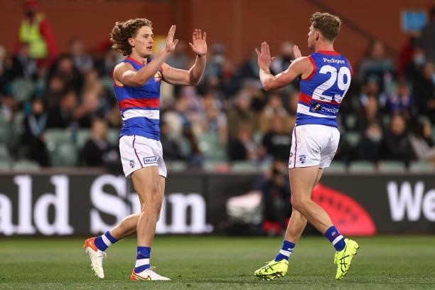 Aaron Naughton of the Bulldogs is congratulated by team mates after kicking a goal during the AFL Second Preliminary Final match between Port...