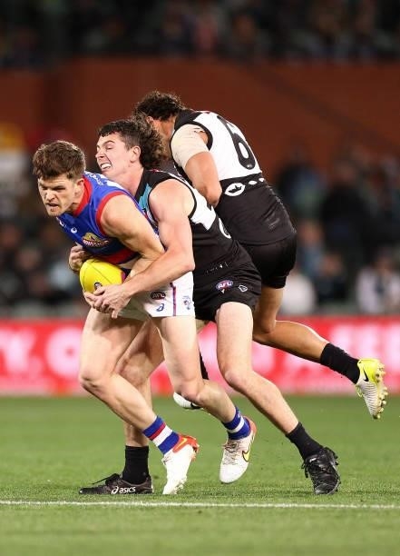 Taylor Duryea of the Bulldogs is tackled by Darcy Byrne-Jones of the Power during the AFL Second Preliminary Final match between Port Adelaide Power...