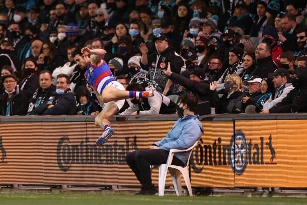 Easton Wood of the Bulldogs jumps back over the fence after ending up in the crowd during the AFL Second Preliminary Final match between Port...