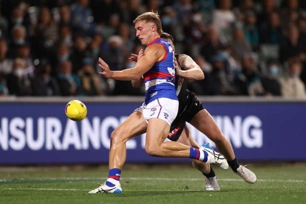 Roarke Smith of the Bulldogs kicks whilst being tackled during the AFL Second Preliminary Final match between Port Adelaide Power and Western...