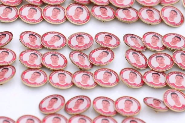 Pin badges with the face of Cristiano Ronaldo of Manchester United are seen being sold outside the stadium prior to the Premier League match between...