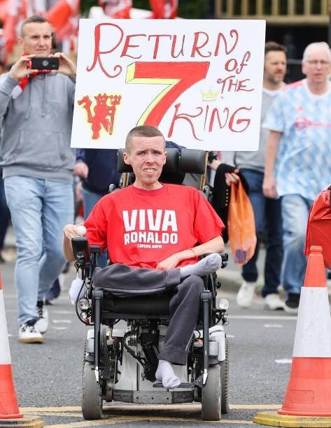 Fan is seen with a 'Return of the King - 7' sign and a 'Viva Ronaldo - Coming Home' shirt outside the stadium prior to the Premier League match...
