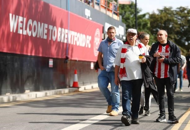 Fans of Brentford make their way towards the stadium prior to the Premier League match between Brentford and Brighton & Hove Albion at Brentford...