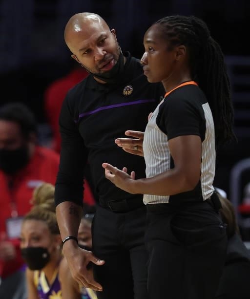 Head coach Derek Fisher of the Los Angeles Sparks with WNBA umpire Karleena Tobin in the second quarter at Staples Center on September 09, 2021 in...