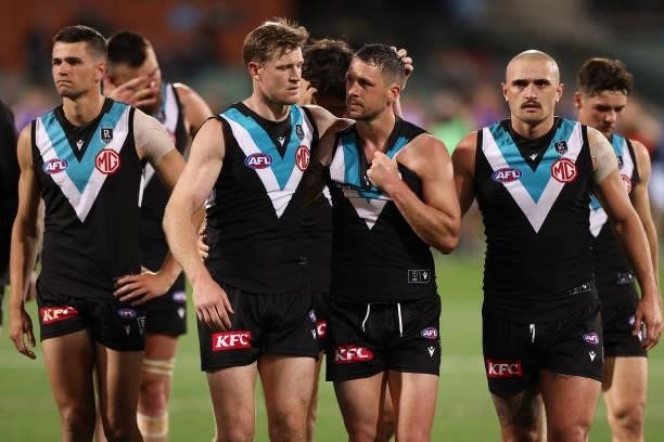 Tom Jonas, Travis Boak and Sam Powell-Pepper of the Power look dejected after losing the AFL Second Preliminary Final match between Port Adelaide...