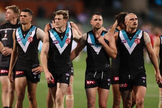 Tom Jonas, Travis Boak and Sam Powell-Pepper of the Power look dejected after losing the AFL Second Preliminary Final match between Port Adelaide...