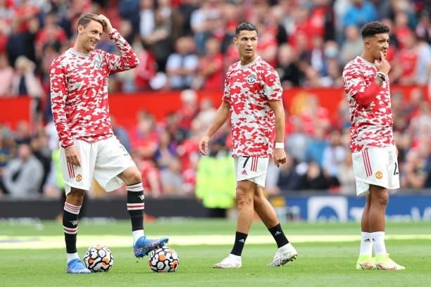 Nemanja Matic, Cristiano Ronaldo and Jadon Sancho of Manchester United look on as they warm up prior to the Premier League match between Manchester...