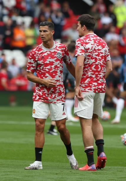 Cristiano Ronaldo and Harry Maguire of Manchester United warms up ahead of the Premier League match between Manchester United and Newcastle United at...