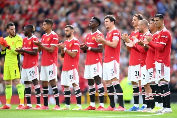 Players of Manchester United take part in a minutes applause in remembrance of the victims of the 9/11 terror attacks prior to the Premier League...