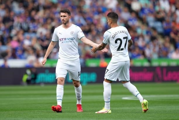 Aymeric Laporte of Manchester City interacts with team mate Joao Cancelo prior to the Premier League match between Leicester City and Manchester City...