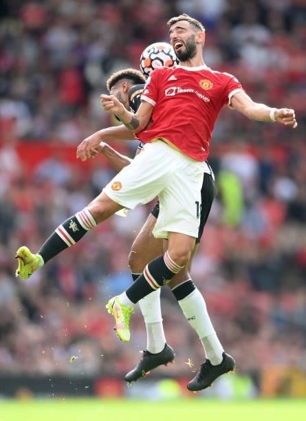 Bruno Fernandes of Manchester United competes for a header with Joelinton of Newcastle United during the Premier League match between Manchester...