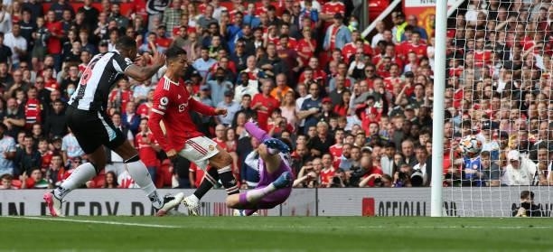 Cristiano Ronaldo of Manchester United scores their first goal during the Premier League match between Manchester United and Newcastle United at Old...