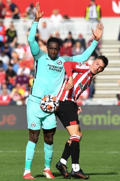Danny Welbeck of Brighton & Hove Albion battles for possession with Sergi Canos of Brentford during the Premier League match between Brentford and...