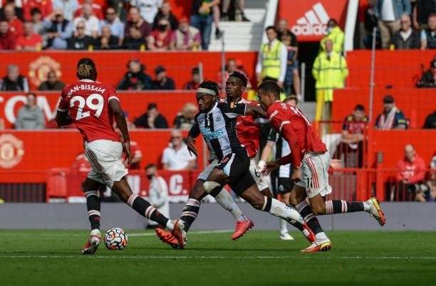 Allan Saint-Maximin of Newcastle United FC runs with the ball surrounded by Manchester players during the Premier League match between Manchester...