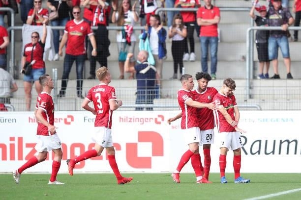 Noah Weisshaupt of SC Freiburg celebrates with team mates after scoring their side's first goal during the Bundesliga match between Sport-Club...