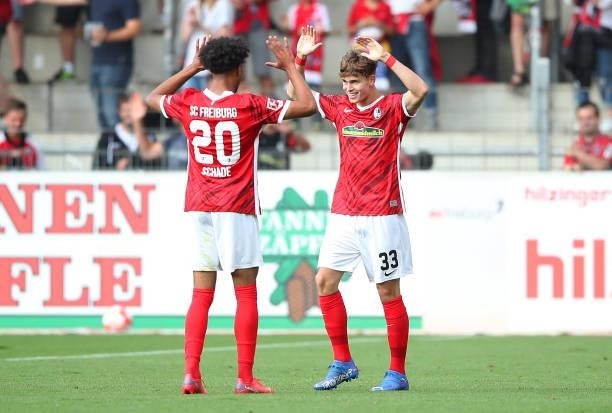 Noah Weisshaupt of SC Freiburg celebrates with Kevin Schade after scoring their side's first goal during the Bundesliga match between Sport-Club...