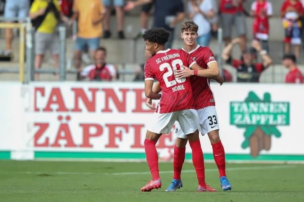 Noah Raphael Weisshaupt of SC Freiburg celebrates after scoring their side`s first goal with teammate Kevin Schande of SC Freiburg during the...