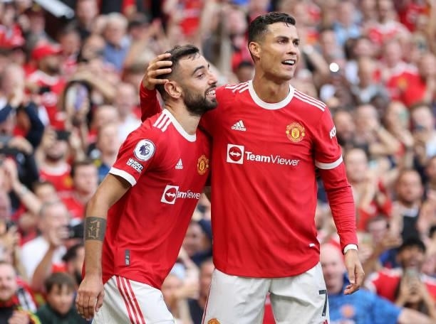 Bruno Fernandes of Manchester United celebrates with Cristiano Ronaldo after scoring their side's third goal during the Premier League match between...