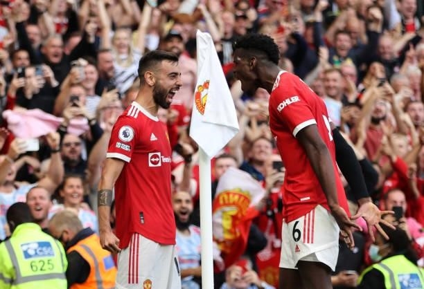 Bruno Fernandes of Manchester United celebrates with Paul Pogba after scoring their side's third goal during the Premier League match between...