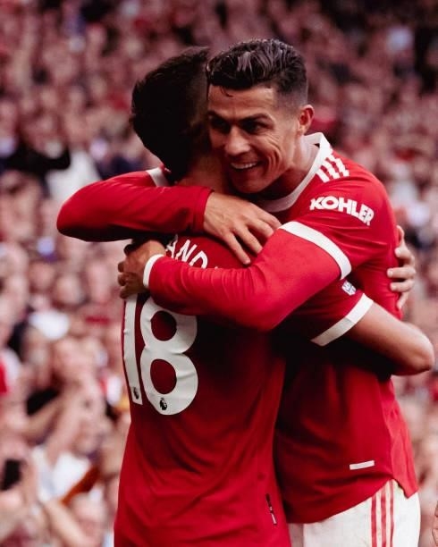 Bruno Fernandes of Manchester United celebrates scoring their third goal with Cristiano Ronaldo during the Premier League match between Manchester...