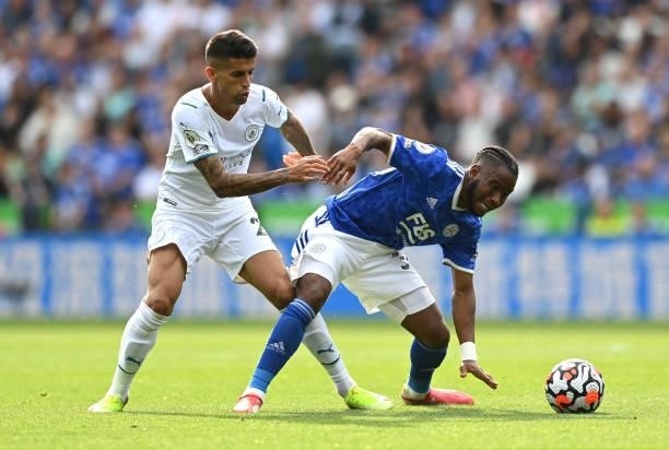 Ademola Lookman of Leicester City battles for possession with Joao Cancelo of Manchester City during the Premier League match between Leicester City...