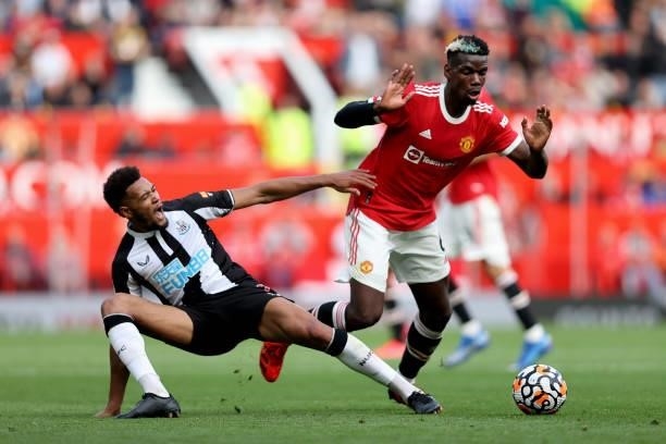 Paul Pogba of Manchester United is challenged by Joelinton of Newcastle United during the Premier League match between Manchester United and...