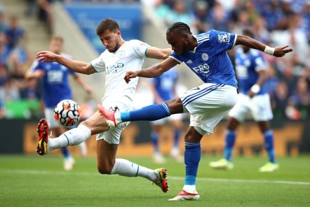 Ademola Lookman of Leicester City shoots whilst under pressure from Ruben Dias of Manchester City during the Premier League match between Leicester...