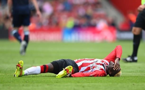 Moussa Djenepo of Southampton lies injured during the Premier League match between Southampton and West Ham United at St Mary's Stadium on September...