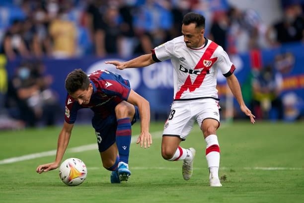 Pablo Martinez of Levante UD competes for the ball with Alvaro Garcia of Rayo Vallecano during the La Liga Santander match between Levante UD and...