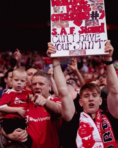 Manchester United fans watch from the stand during the Premier League match between Manchester United and Newcastle United at Old Trafford on...