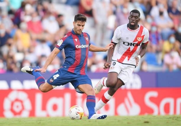 Rober Pier of Levante makes a pass whilst under pressure from Randy Nteka of Rayo Vallecano during the LaLiga Santander match between Levante UD and...