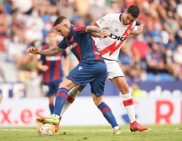 Roger of Levante battles for possession with Santi Comesana of Rayo Vallecano during the LaLiga Santander match between Levante UD and Rayo Vallecano...