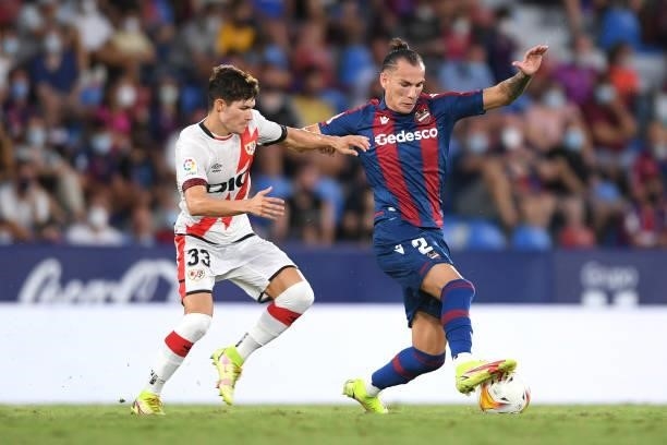Son of Levante battles for possession with Fran Garcia of Rayo Vallecano during the LaLiga Santander match between Levante UD and Rayo Vallecano at...