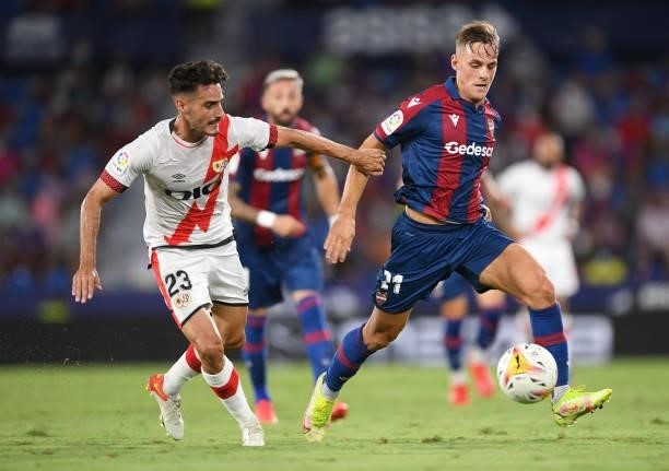 Dani Gomez of Levante battles for possession with Oscar Valentin of Rayo Vallecano during the LaLiga Santander match between Levante UD and Rayo...