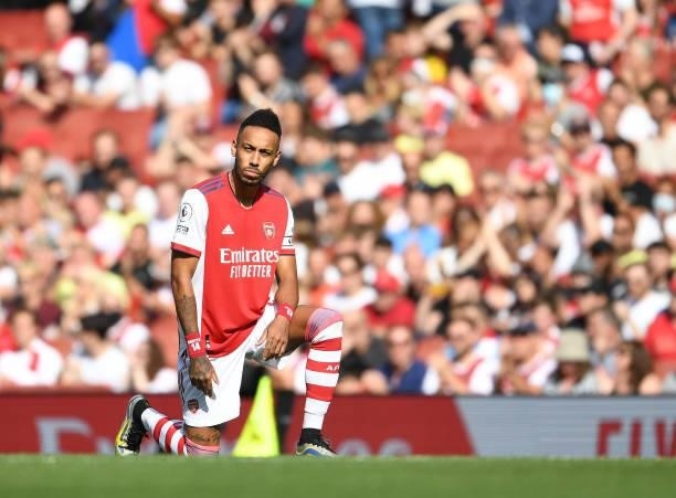 Arsenal captain Pierre-Emerick Aubameyang takes a knee before the Premier League match between Arsenal and Norwich City at Emirates Stadium on...