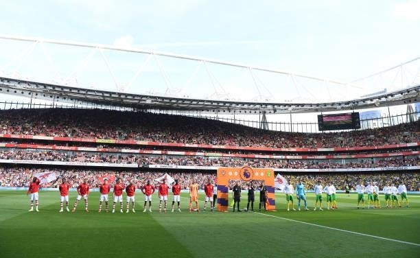 The Arsenal and Norwich teams line up before the Premier League match between Arsenal and Norwich City at Emirates Stadium on September 11, 2021 in...