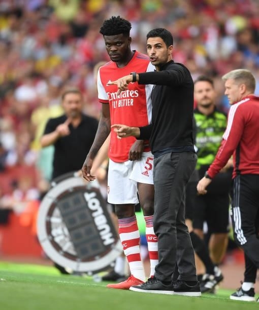 Arsenal manager Mikel Arteta with Thomas Partey during the Premier League match between Arsenal and Norwich City at Emirates Stadium on September 11,...