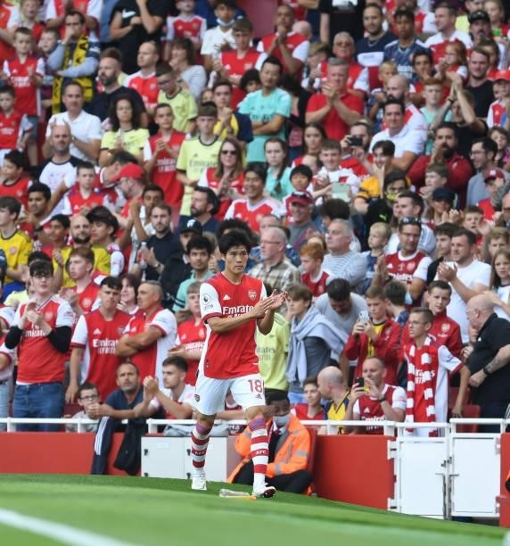 Takehiro Tomiyasu applauds the Arsenal fans after his substitution during the Premier League match between Arsenal and Norwich City at Emirates...
