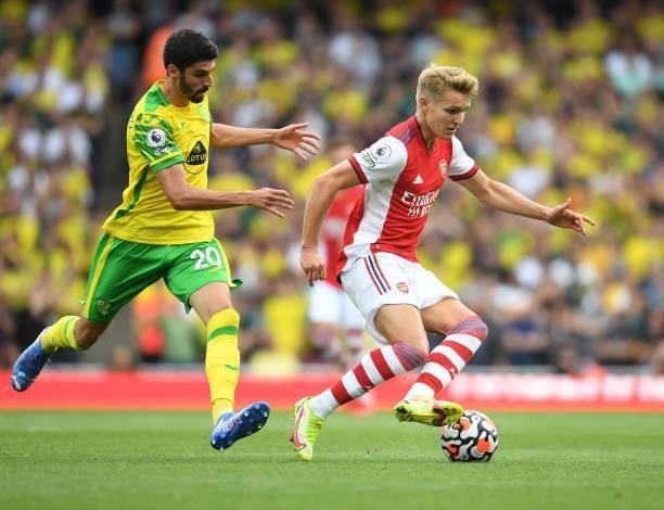 Martin Odegaard of Arsenal breaks past Pierre Lees-Melou of Norwich during the Premier League match between Arsenal and Norwich City at Emirates...