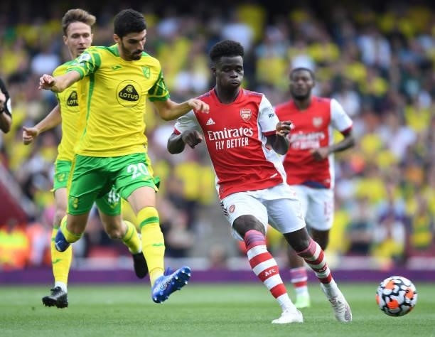 Bukayo Saka of Arsenal breaks past Pierre Lees-Melou of Norwich during the Premier League match between Arsenal and Norwich City at Emirates Stadium...