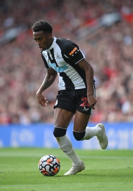 Joe Willock of Newcastle United runs with the ball during the Premier League match between Manchester United and Newcastle United at Old Trafford on...