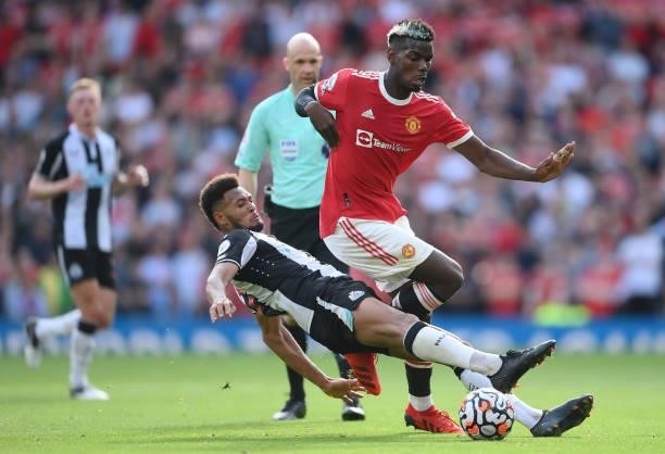 Paul Pogba of Manchester United battle for possession with Joelinton of Newcastle United during the Premier League match between Manchester United...
